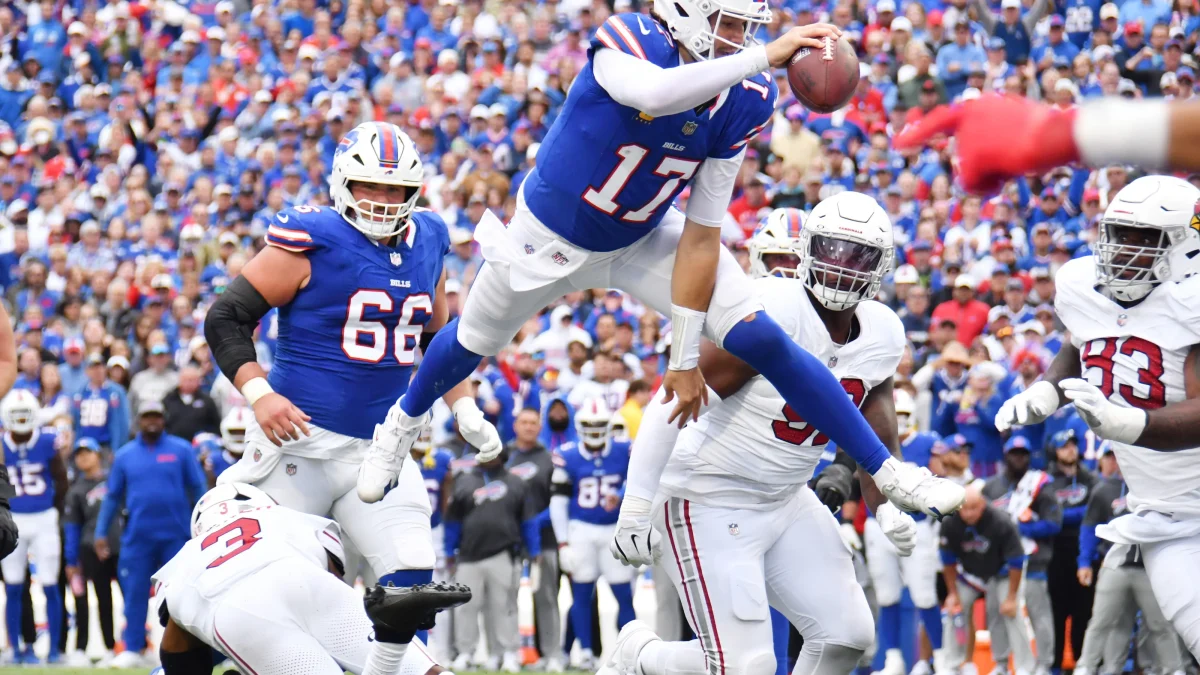 Josh Allen jumping over a Cardinal for a touchdown. Photo from Democrat and Chronicle