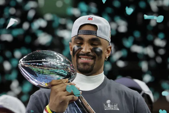 Superbowl MVP Jalen Hurts holding the Lombardi Trophy. Photo from Aljazeera.